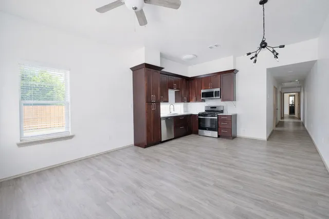 a view of a kitchen with a sink cabinets and wooden floor