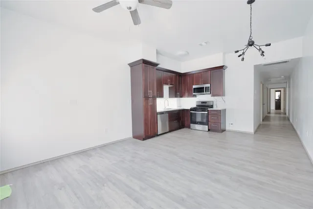 a view of a kitchen with a sink and a refrigerator