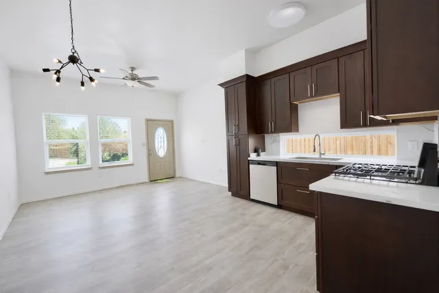 a kitchen with a stove a sink and a refrigerator