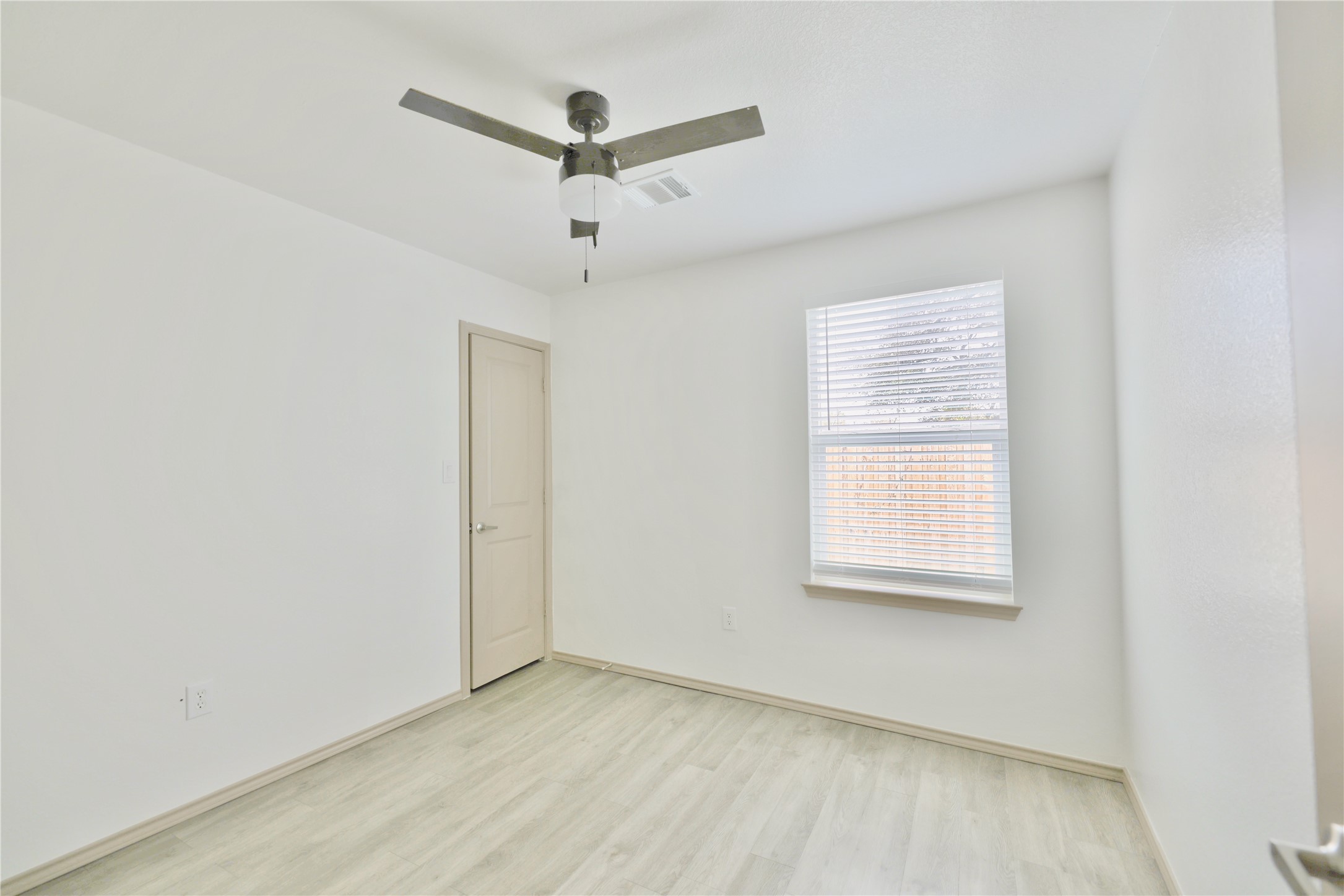 113 Bolden Street, Unit A Houston, TX 77029 - Photo 7 of 14 an empty room with a window and a fan