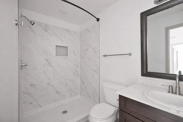 a bathroom with a sink toilet and shower