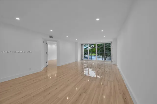 a view of a room with wooden floor and window