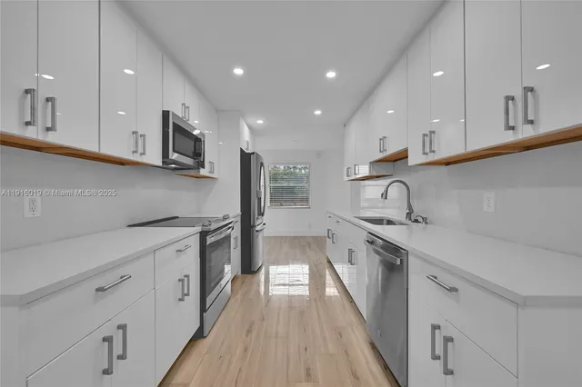 a kitchen with stainless steel appliances granite countertop a sink and stove top oven