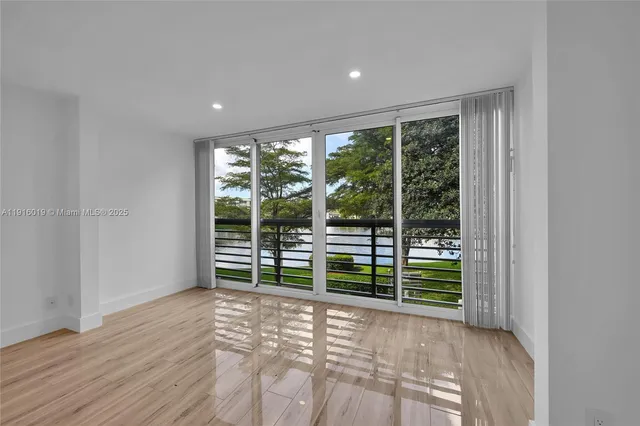 a view of a room with wooden floor and windows