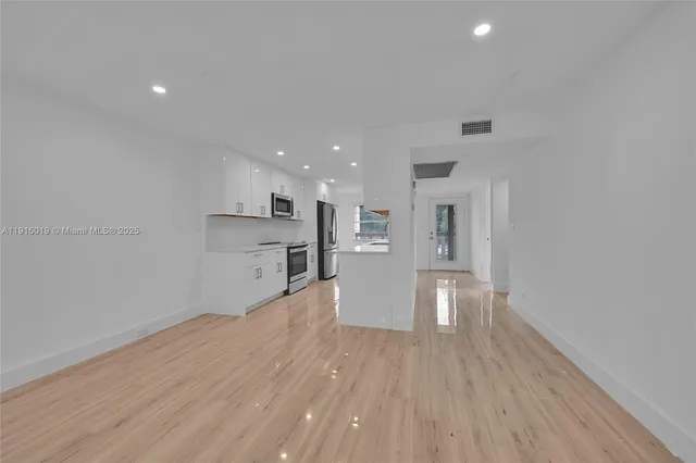a view of kitchen and wooden floor