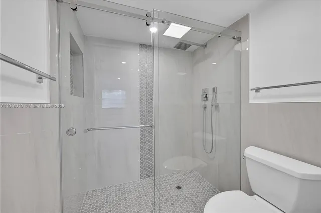 a bathroom with a shower toilet and sink