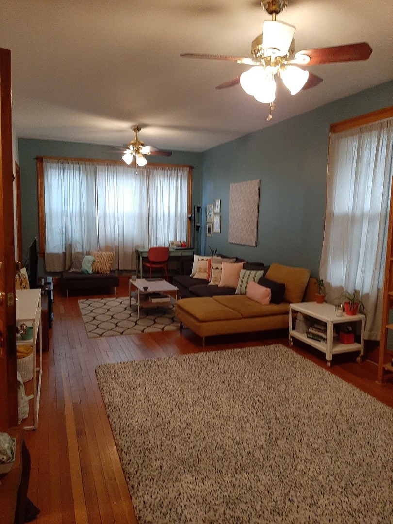 3142 South Morgan Street Chicago, IL 60608 - Photo 14 of 22 a living room with furniture a chandelier and a rug