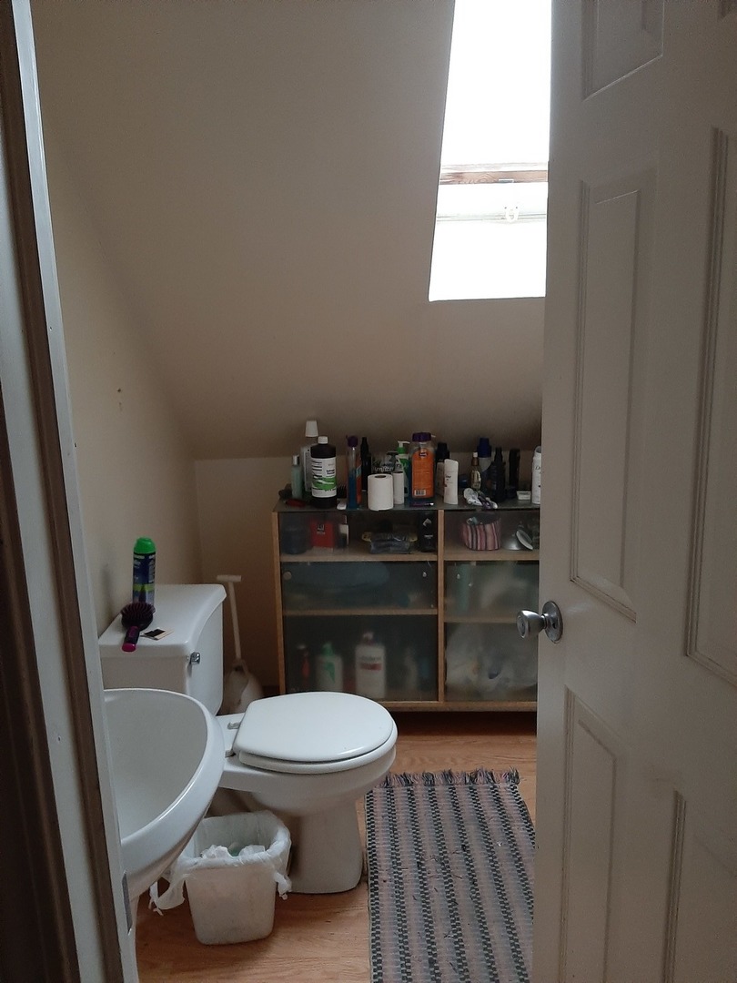 3142 South Morgan Street Chicago, IL 60608 - Photo 17 of 22 a bathroom with a toilet a sink and a window