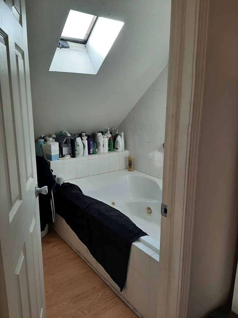 3142 South Morgan Street Chicago, IL 60608 - Photo 19 of 22 a en suite bathroom with a sink and a mirror