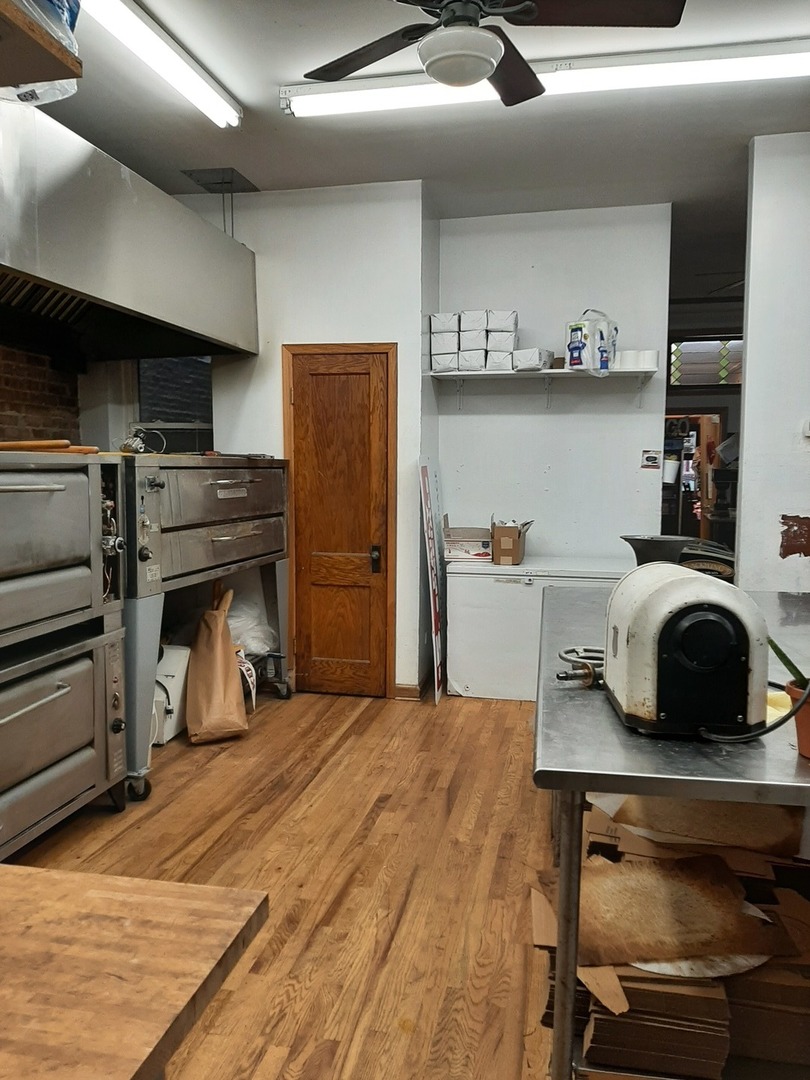 3142 South Morgan Street Chicago, IL 60608 - Photo 5 of 22 a bedroom with a bed and a fireplace