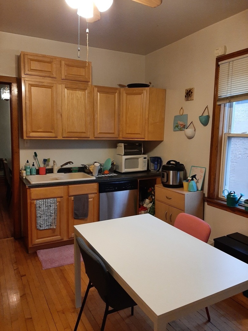 3142 South Morgan Street Chicago, IL 60608 - Photo 6 of 22 a kitchen with a table chairs sink and cabinets