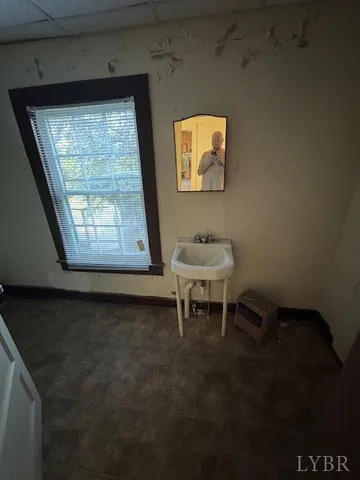 a white bench sitting in a room next to a window