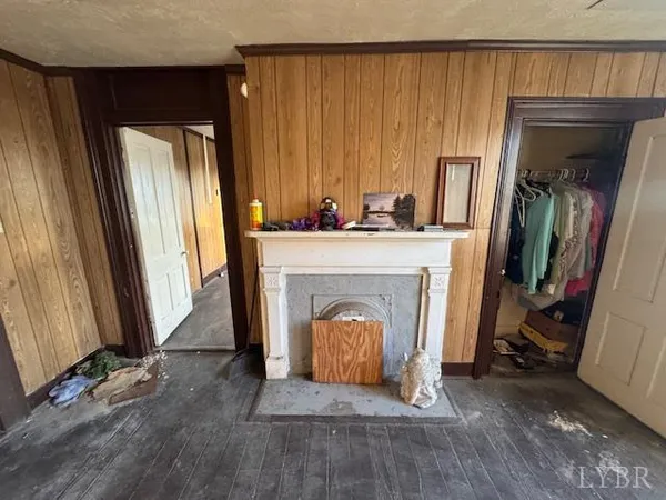 a view of an empty room with a fireplace and a window