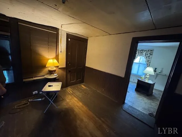 a room with furniture and view of kitchen