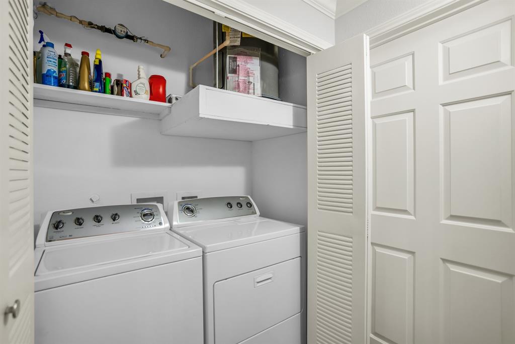 2524 Preston Road, Unit 808 Plano, TX 75093 - Photo 22 of 31 Dedicated laundry area featuring a washer and dryer, an overhead shelf for storage, and bi-fold louvered doors