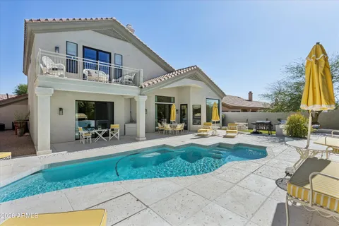 a front view of a house with swimming pool having outdoor seating