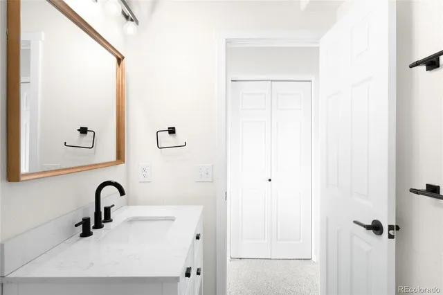 a bathroom with a sink and mirror