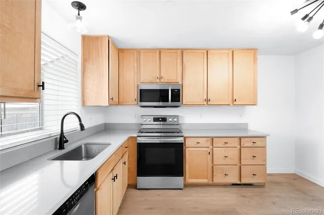 a kitchen with stainless steel appliances a stove sink and cabinets