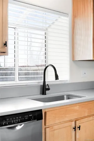 a kitchen with a sink and a window