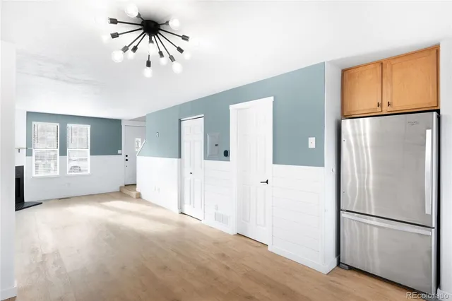 a view of a kitchen with a refrigerator and a window
