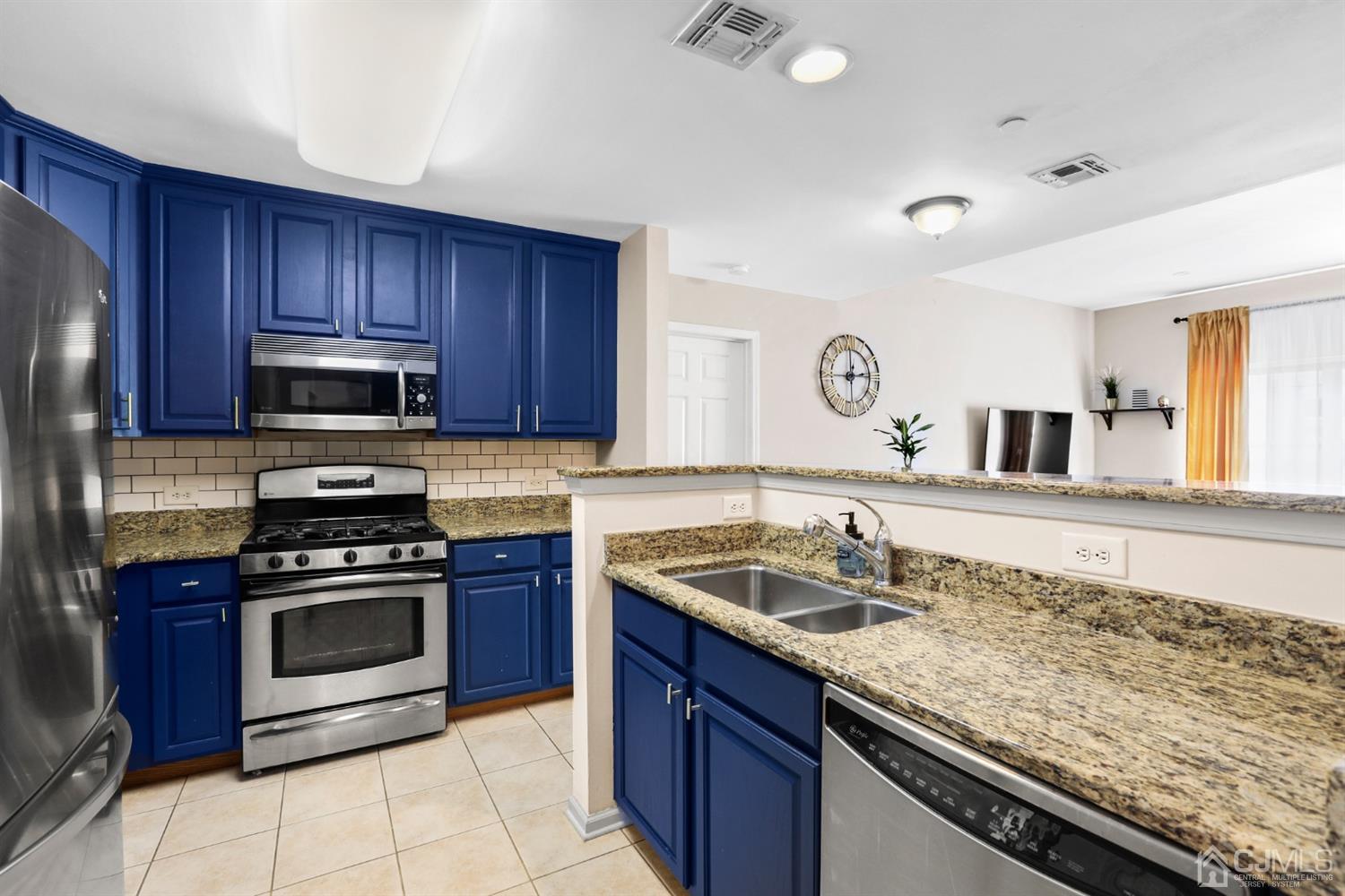 358 Rector Street, Unit 706 Perth Amboy, NJ 08861 - Photo 1 of 20 a kitchen with granite countertop a sink stainless steel appliances and cabinets