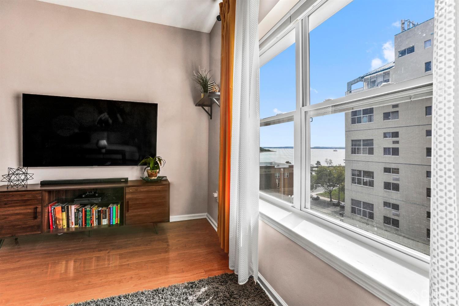 358 Rector Street, Unit 706 Perth Amboy, NJ 08861 - Photo 11 of 20 a living room with flat screen tv and a floor to ceiling window