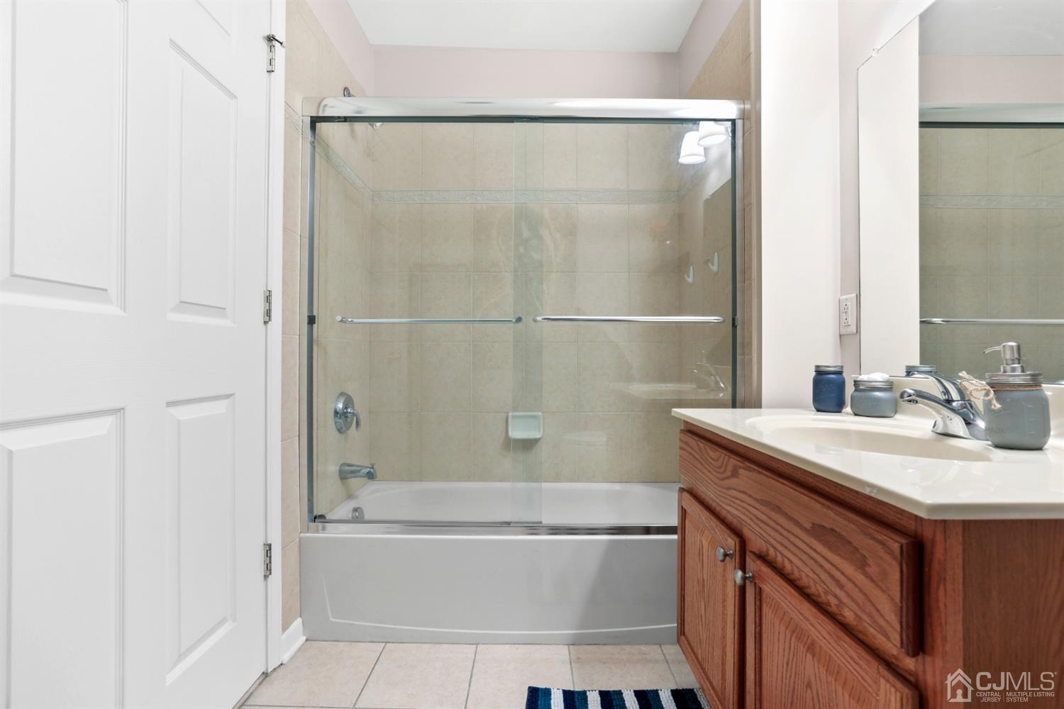 358 Rector Street, Unit 706 Perth Amboy, NJ 08861 - Photo 13 of 20 a bathroom with a granite countertop bathtub shower sink vanity and toilet
