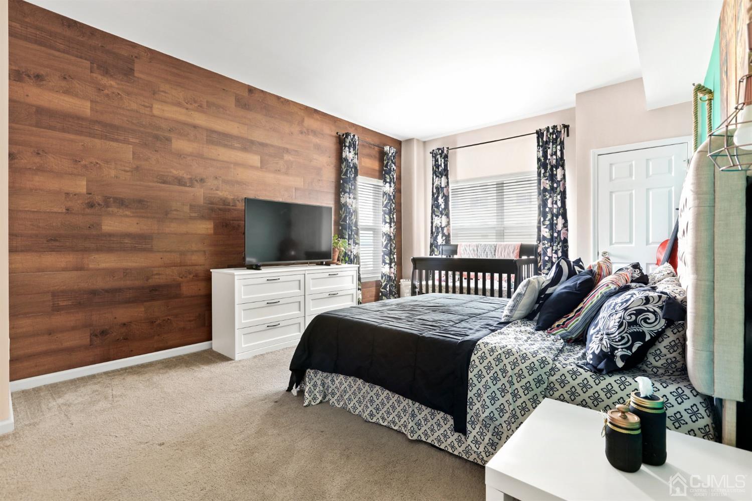 358 Rector Street, Unit 706 Perth Amboy, NJ 08861 - Photo 16 of 20 a bedroom with a bed and a flat screen tv