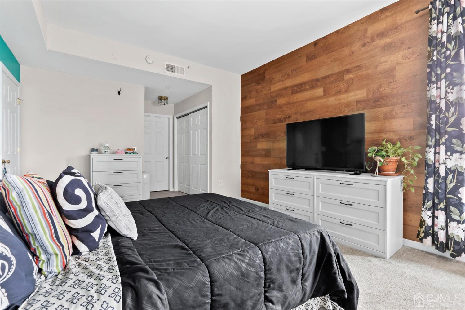 358 Rector Street, Unit 706 Perth Amboy, NJ 08861 - Photo 17 of 20 a bedroom with a bed and a flat screen tv