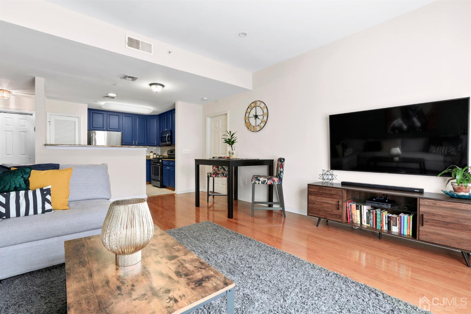 358 Rector Street, Unit 706 Perth Amboy, NJ 08861 - Photo 6 of 20 a living room with furniture and a flat screen tv