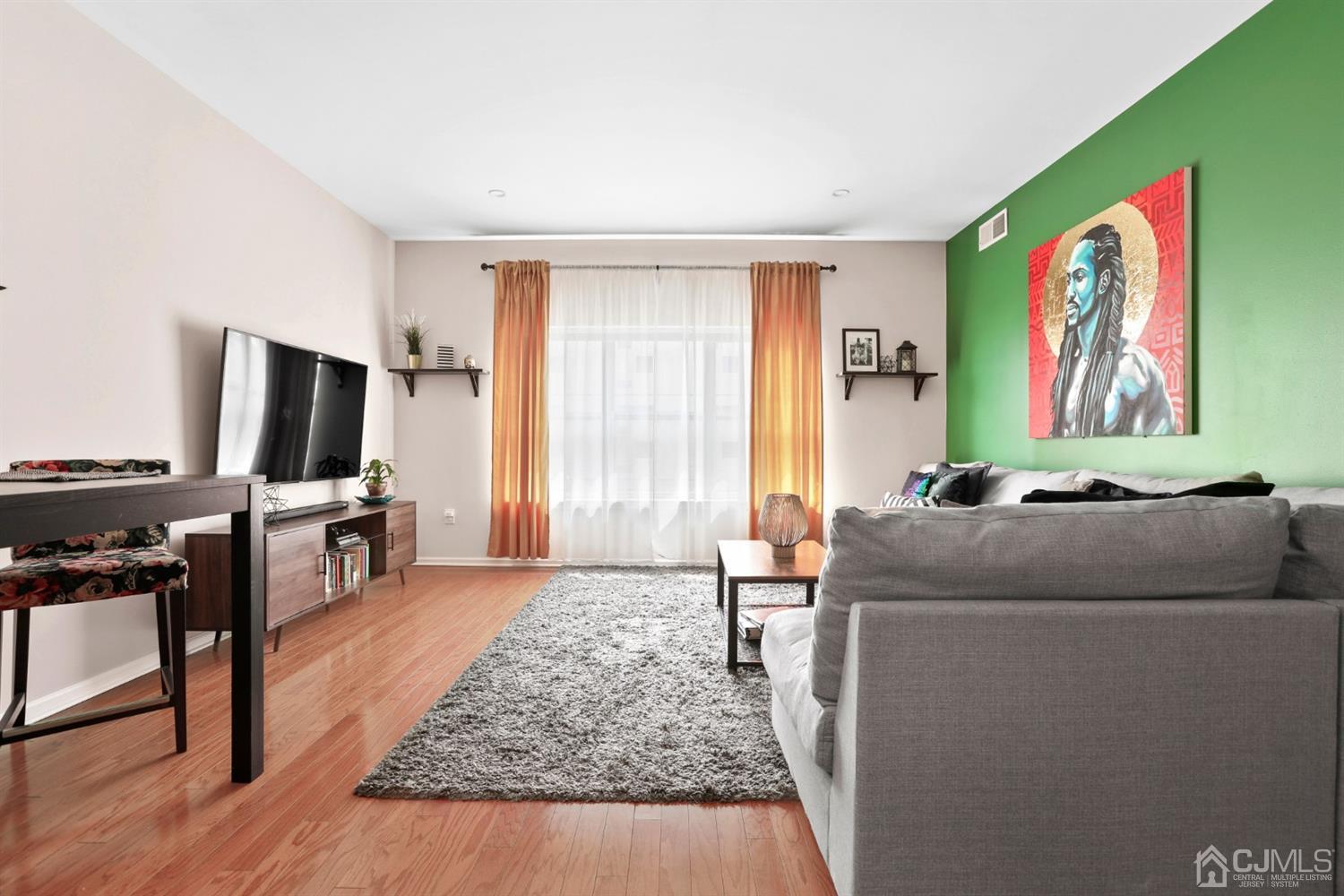 358 Rector Street, Unit 706 Perth Amboy, NJ 08861 - Photo 8 of 20 a living room with furniture and a flat screen tv