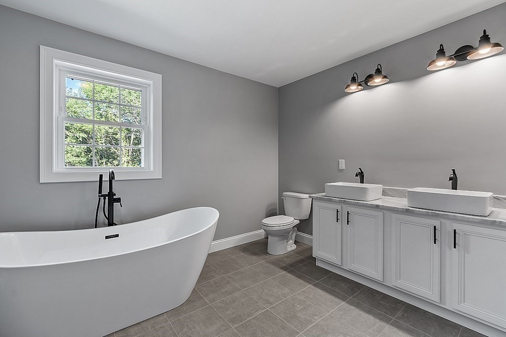 131 French Road, Unit LOT 10 Templeton, MA 01468 - Photo 32 of 35 a bathroom with a toilet sink and mirror