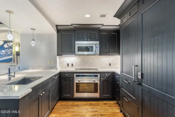 a kitchen with a sink stove and cabinets