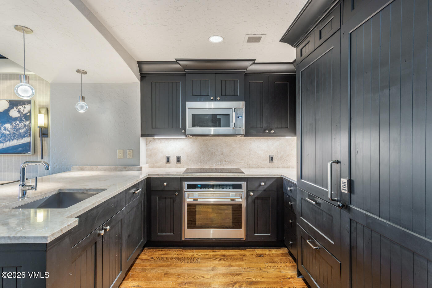 130 Daybreak Ridge Road, Unit HS725 Avon, CO 81620 - Photo 12 of 38 a kitchen with a sink stove and cabinets