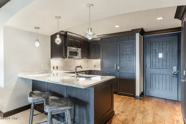 a kitchen with kitchen island a sink stove and refrigerator