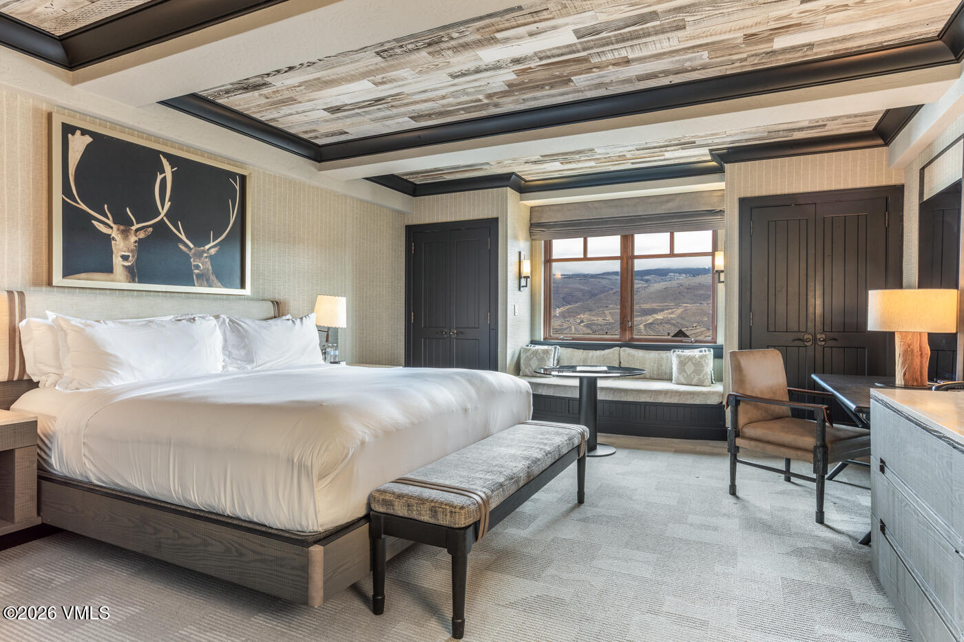 130 Daybreak Ridge Road, Unit HS725 Avon, CO 81620 - Photo 18 of 38 a bedroom with a bed and a chandelier