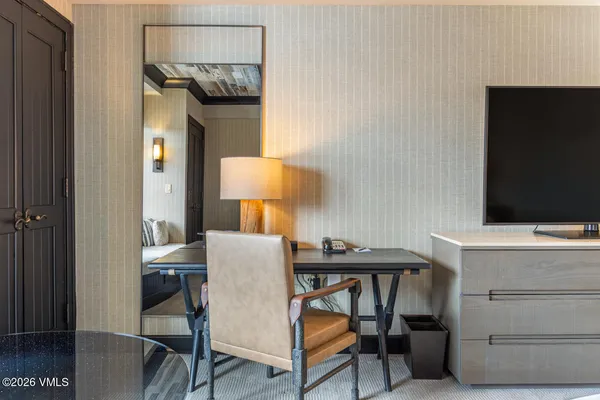 a view of a workspace room with furniture and wooden floor