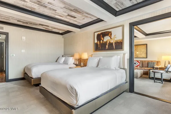 a bedroom with a bed and glass walk in closet