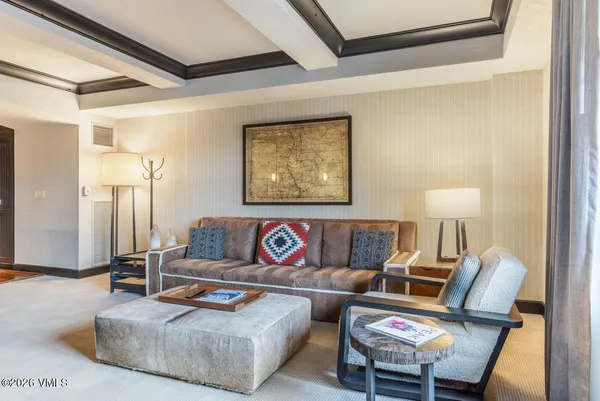 a living room with furniture and a lamp