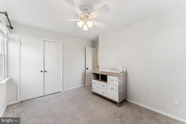 a bathroom with a granite countertop sink mirror vanity and toilet