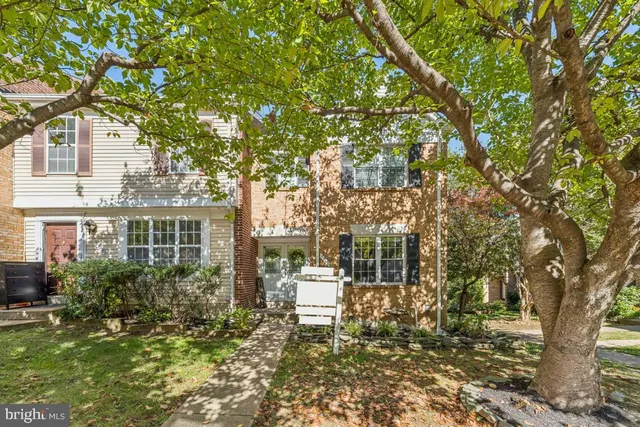 a view of a house with a tree in front