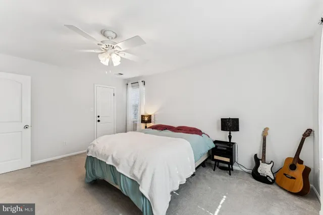 a bedroom with a bed and a flat tv screen