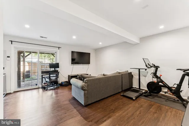 a bathroom with a granite countertop sink vanity mirror and toilet