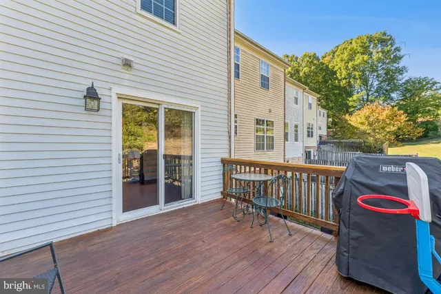 a view of balcony with wooden floor and fence