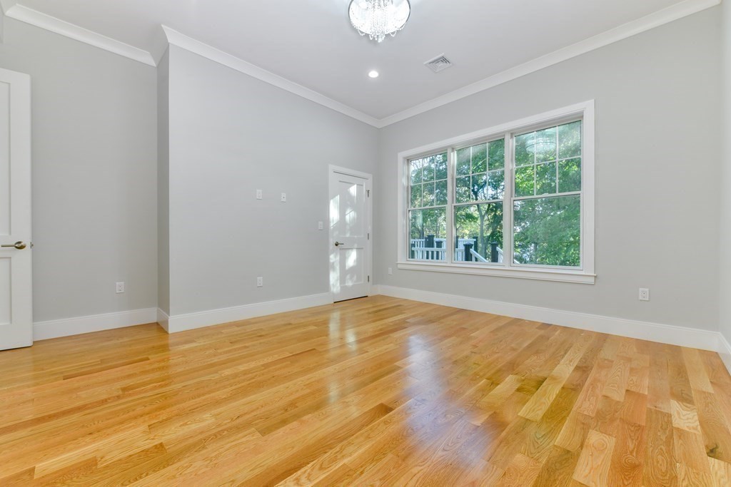 70 Helene Road Newton, MA 02468 - Photo 16 of 35 an empty room with wooden floor and windows