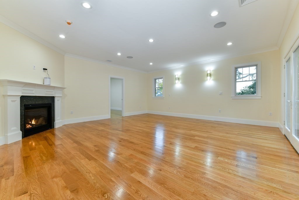 70 Helene Road Newton, MA 02468 - Photo 18 of 35 a view of an empty room with wooden floor fireplace and a window