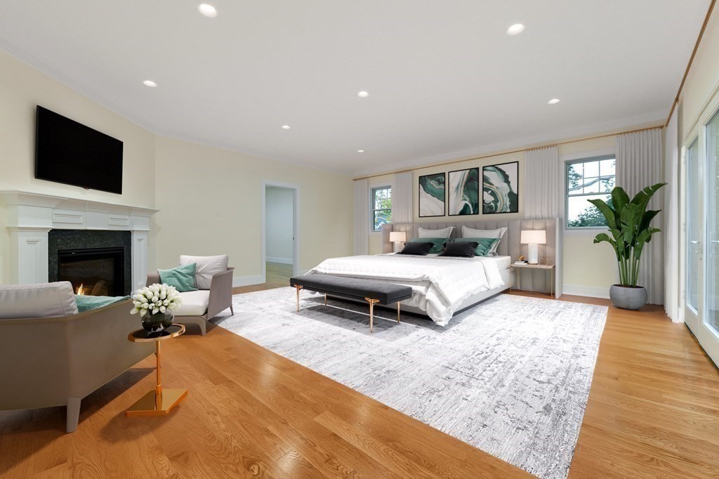 70 Helene Road Newton, MA 02468 - Photo 19 of 35 a bedroom with a bed a couch and a flat screen tv