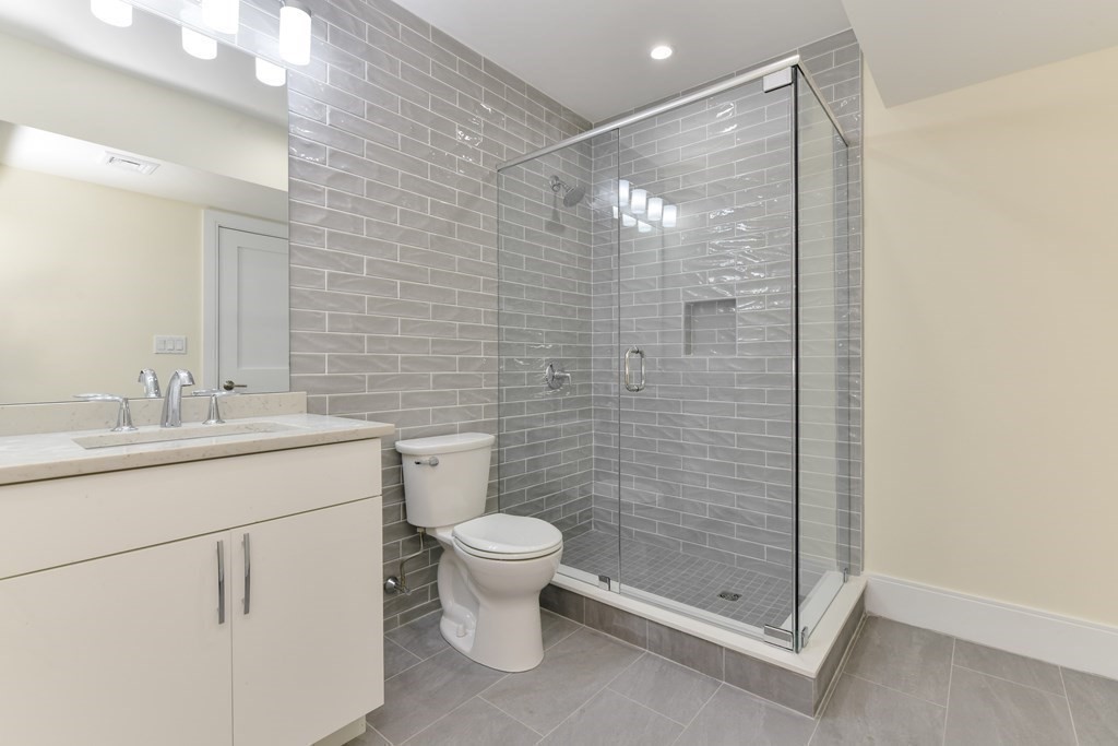 70 Helene Road Newton, MA 02468 - Photo 27 of 35 a bathroom with a shower sink vanity and toilet