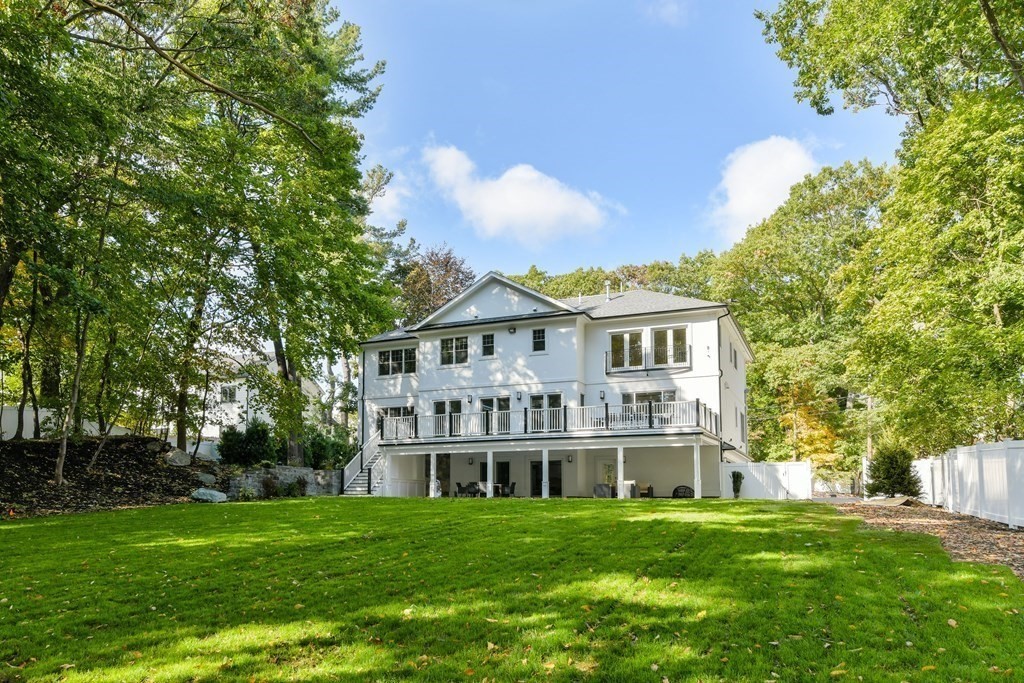 70 Helene Road Newton, MA 02468 - Photo 5 of 35 a view of a big house with a big yard and large trees
