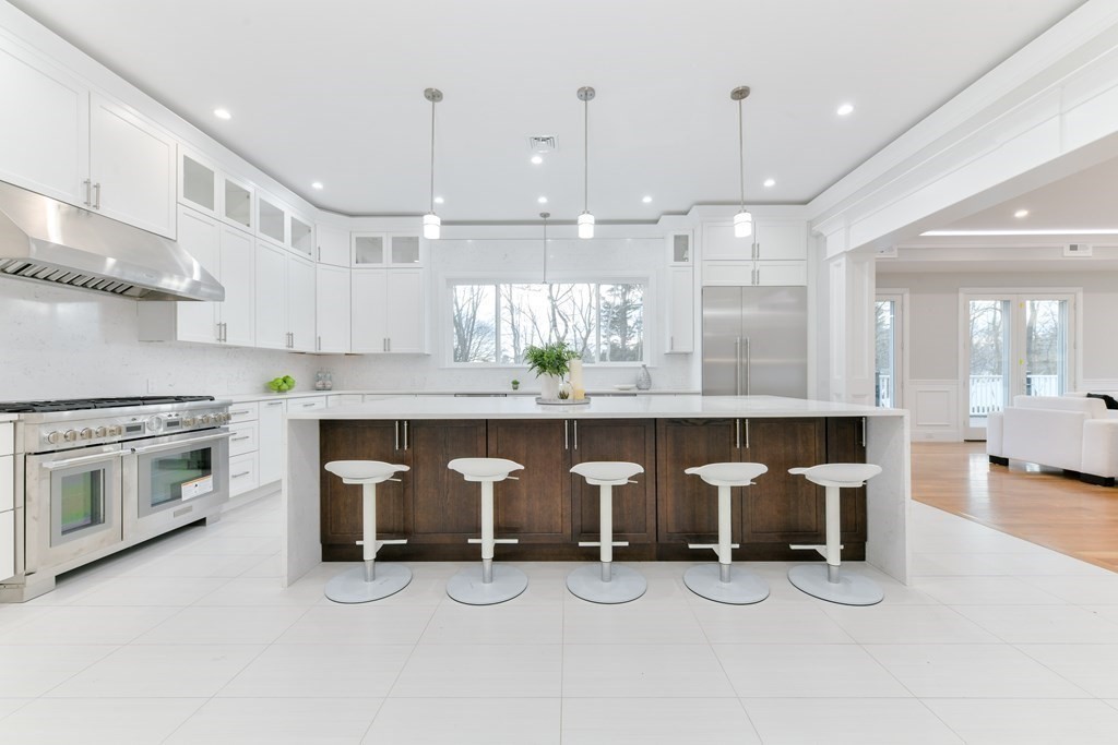70 Helene Road Newton, MA 02468 - Photo 10 of 35 a view of a kitchen with stainless steel appliances granite countertop a stove and a refrigerator